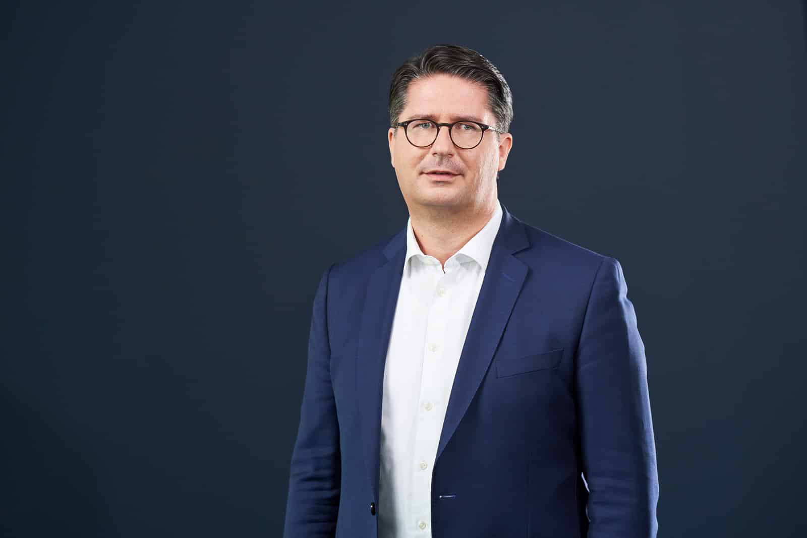 Home 20 Business-Portrait eines Mannes im dunklen Anzug.